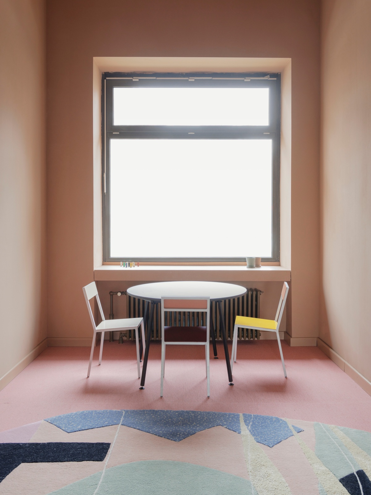 Chairs and table in front of window